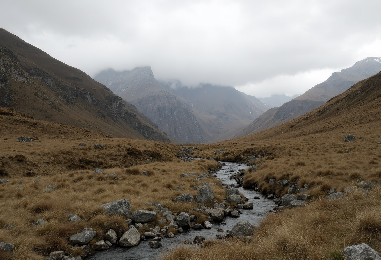 Imagiograph of a stream flowing between mountains.